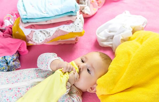 Baby scattered clothes and toys. Selective focus. people.