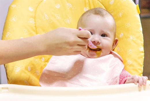 Mom feeds baby with vegetable puree. Selective focus. Food.