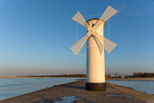 Stawa Mlyny, a beacon in the shape of a windmill as an official symbol of Swinoujscie at sunset