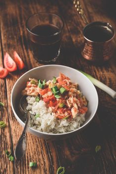 Scrambled eggs with tomatoes, leek and white rice. Turkish coffee and sliced ingredients.