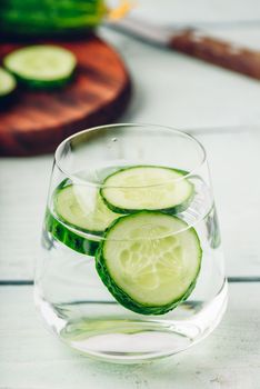 Water infused with sliced cucumber in a drinking glass