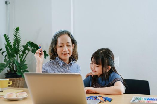 Asian portrait, grandchild granddaughter grandma grandmother and granddaughter happily join in activities to enhance skills for grandchildren.