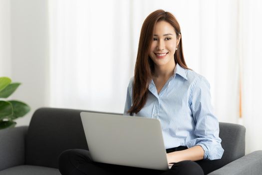 A portrait of Asian happy Businesswoman smiling and working at office