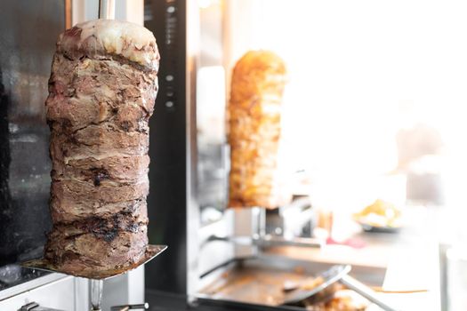 Traditional Turkish fast food, Vertical rotisserie with hot and fresh meat for Doner Kebab, copy space.