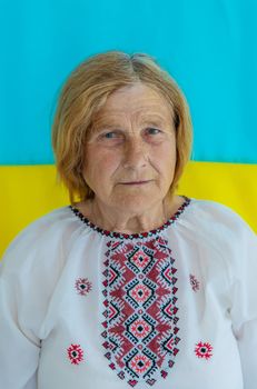 Grandmother is a Ukrainian patriot in an embroidered shirt. selective focus. People.