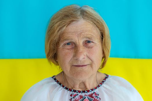 Grandmother is a Ukrainian patriot in an embroidered shirt. selective focus. People.