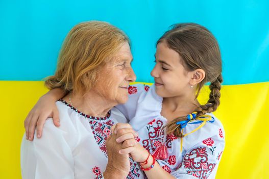 Ukrainian grandmother and granddaughter in vyshyvanka. selective focus. Kid.