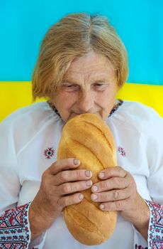 Grandmother is a Ukrainian patriot in an embroidered shirt. selective focus. People.