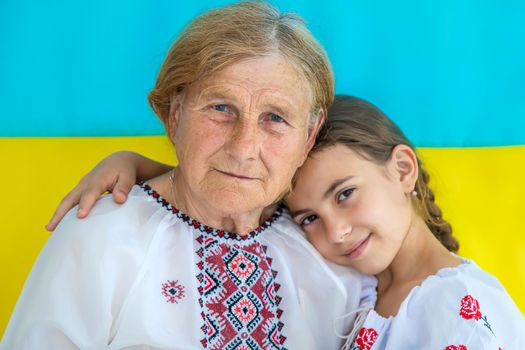 Ukrainian grandmother and granddaughter in vyshyvanka. selective focus. Kid.