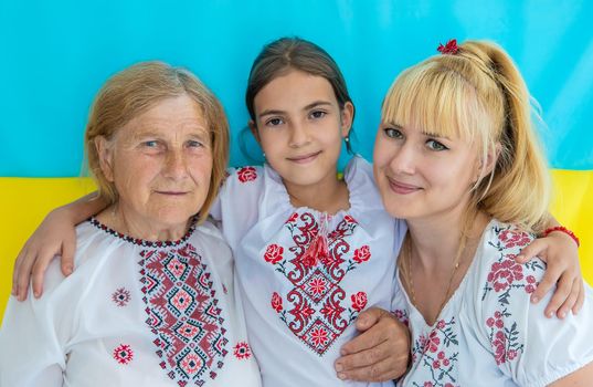 Grandmother and granddaughters in Ukrainian clothes. Selective focus. People.