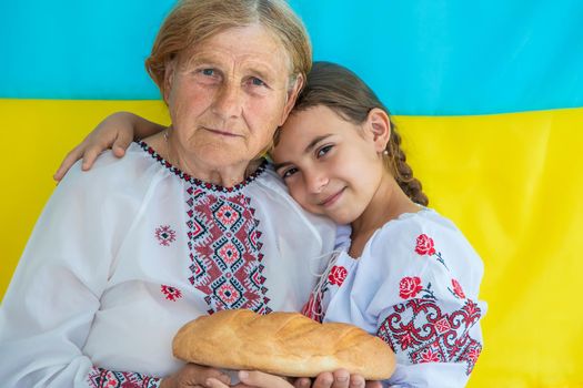 Ukrainian grandmother and granddaughter in vyshyvanka. selective focus. Kid.