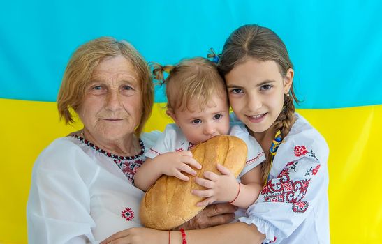 Grandmother and granddaughters in Ukrainian clothes. Selective focus. People.