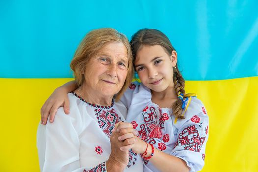 Ukrainian grandmother and granddaughter in vyshyvanka. selective focus. Kid.