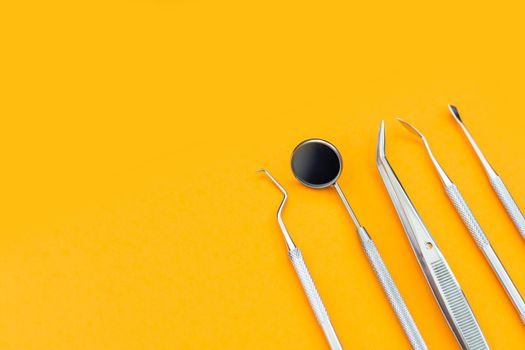 Dentist tools. Teethcare, dental health concept. orange background top view copy space.