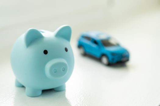 toy car and piggy bank on white background.