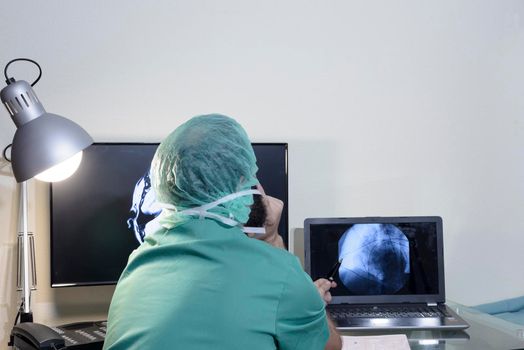 In the medical laboratory, the patient undergoes an MRI or CT scan under the supervision of a radiologist, in the control room, the doctor observes the procedure and monitors the scan results