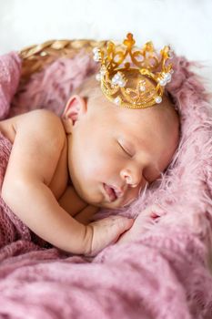 Newborn baby in a girl crown. Selective focus. people.