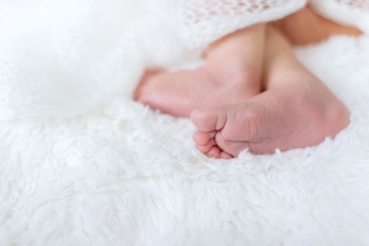 Newborn toddler feet on a white background. Selective focus. people.