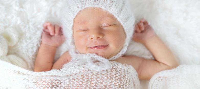 Newborn baby sleeps in a hat. Selective focus. people.