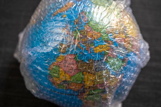 Globe wrapped in bubble wrap plastc still life