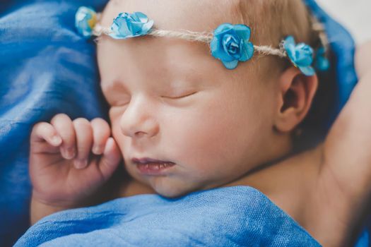 Newborn baby sleeping on a blue background. Selective focus. people.