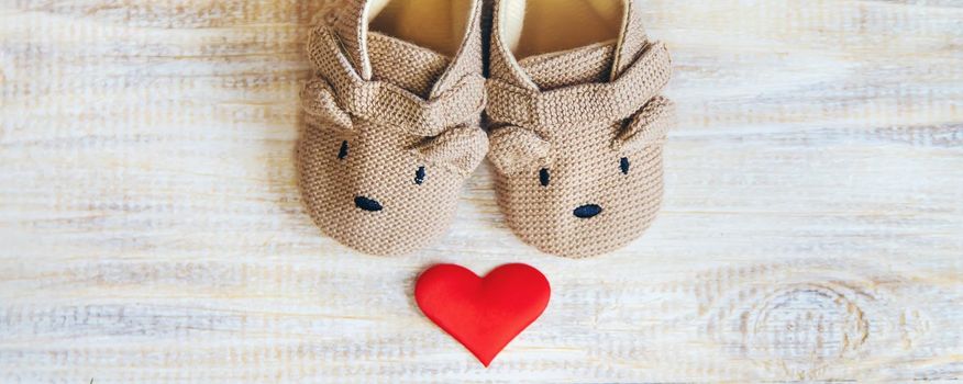Baby booties and heart on a light background. Selective focus. nature.
