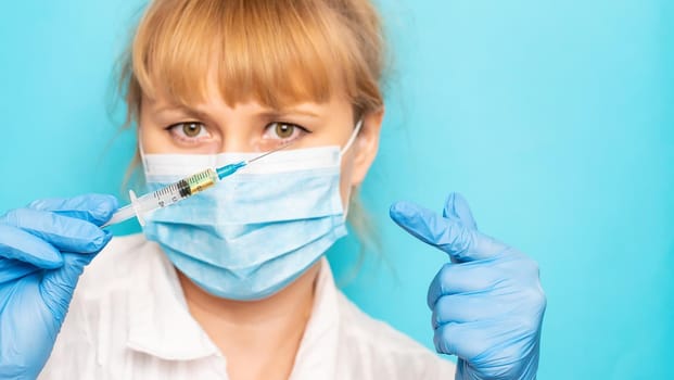 Doctor with a syringe in his hands. Selective focus.