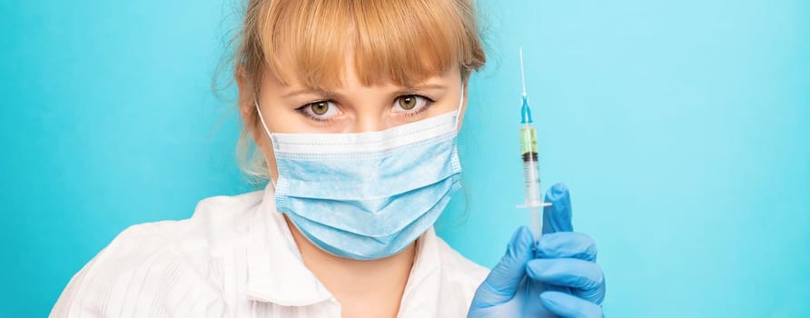 Doctor with a syringe in his hands. Selective focus.