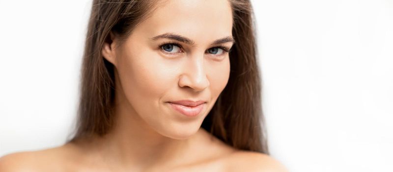 Young caucasian woman beauty face portrait with healthy white skin isolated on white background