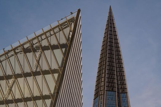 Russia, St. Petersburg, 10 June 2022: The spire of skyscraper Lakhta center of the gas company Gazprom at sunset, glass and iron facade. High quality photo
