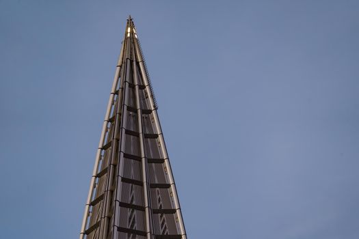 Russia, St. Petersburg, 10 June 2022: The spire of skyscraper Lakhta center of the gas company Gazprom at sunset, glass and iron facade. High quality photo