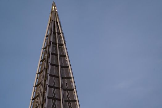 Russia, St. Petersburg, 10 June 2022: The spire of skyscraper Lakhta center of the gas company Gazprom at sunset, glass and iron facade. High quality photo