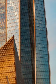 Russia, St. Petersburg, 10 June 2022: The skyscraper Lakhta center of the gas company Gazprom at sunset, glass and iron facade. High quality photo