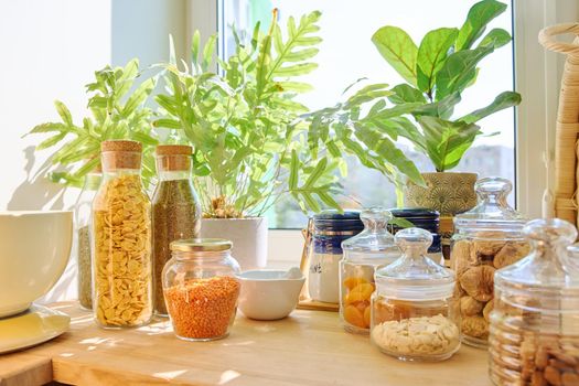 Storage of food in the kitchen in pantry. Dry fruits, figs, nuts, cereal, herbs, kitchen utensils. Cooking at home, household concept