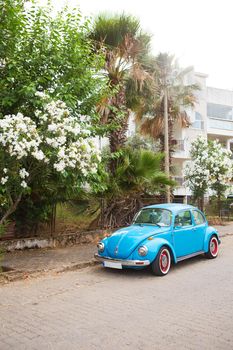 Blue Volkswagen beetle parked in a beautiful area. Turkey, Marmaris