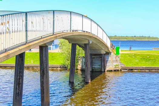 Bad Bederkesa Lake See bridge on sunny day and natural landscape in Geestland Cuxhaven Lower Saxony Germany.