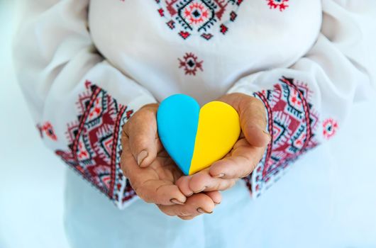 Grandmother is a Ukrainian patriot in an embroidered shirt. selective focus. People.