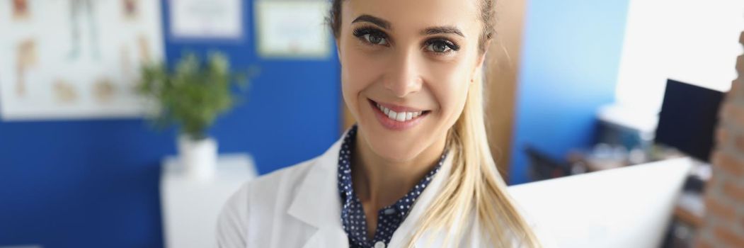 Portrait of cute medical worker or head doctor in uniform posing in clinic office. Qualified female specialist in medicine. Healthcare, appointment concept