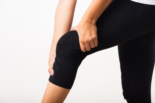 Closeup young woman aches to suffer from pain knee and she uses hand joint hold knee agony, studio shot isolated on white background Rheumatism healthcare and medical physiotherapy therapy concept