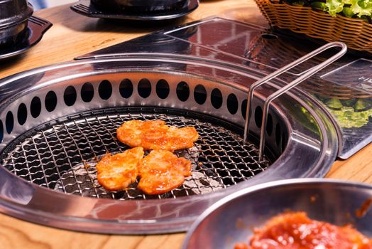 Korean beef barbecue on hot coals. Grilling meat pork Korean BBQ traditional style on stove serve in restaurant, Japanese food