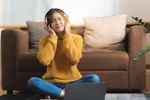 Portrait of Happy Asian artist woman using smart phone and listen music at home. Relax concept