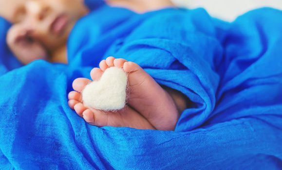 Newborn baby sleeping on a blue background. Selective focus. people.