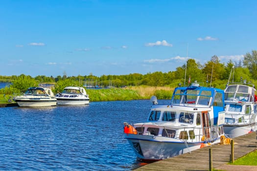 Bad Bederkesa Lake See boats and jetty on sunny day and natural landscape in Geestland Cuxhaven Lower Saxony Germany.