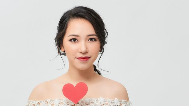 Young beautiful smiling woman having fun with heart stick.