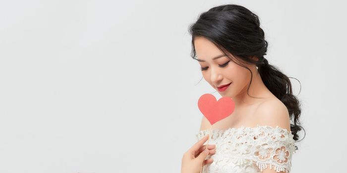 Young beautiful smiling woman having fun with heart stick.