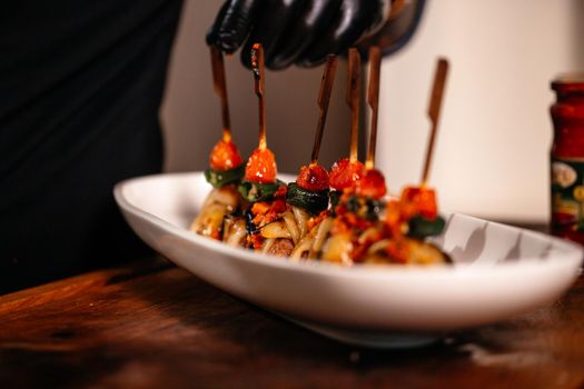 Fried Eggplant with Peppers, tomatoes and Appetizing Fried Beef Meatballs. Food Art Gourmet Dinner Close Up.