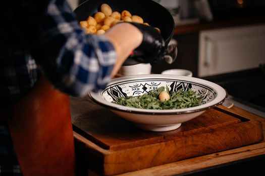 Fresh Arugula and cooked Potatoes Salad. Heathy Food Vegetarian Concept. Close Up.