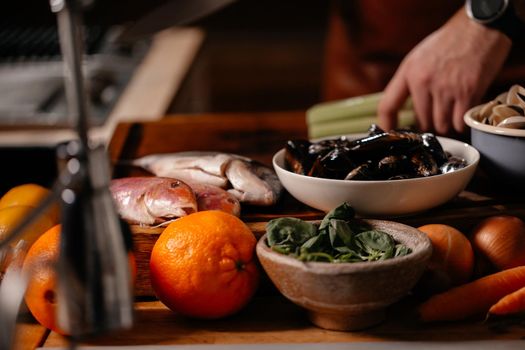 Process of mediterranean dish preparation. Fresh Mollusks Fish Shell Shrimp. Cooking Seafood.