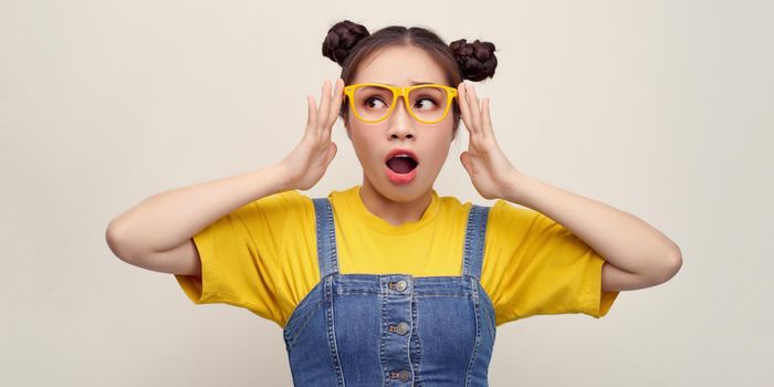 Wow! I don't believe you! Close up portrait of shocked astonished woman with open mouth and big eyes, she is touching her glasses