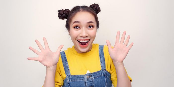 So excited and positive girl isolated on white background loud laughs raising her head and hands up. Concept of advertising, sale and discount